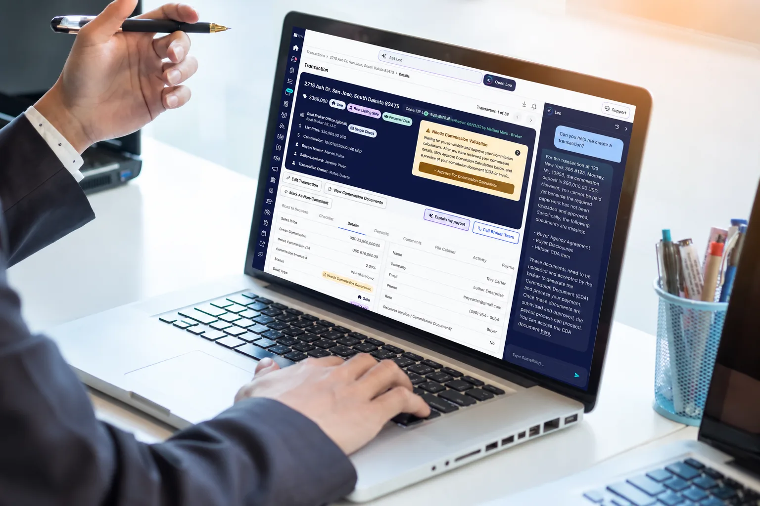 Hands on a laptop showing a transaction in the agent dashboard with the LEO chat panel open